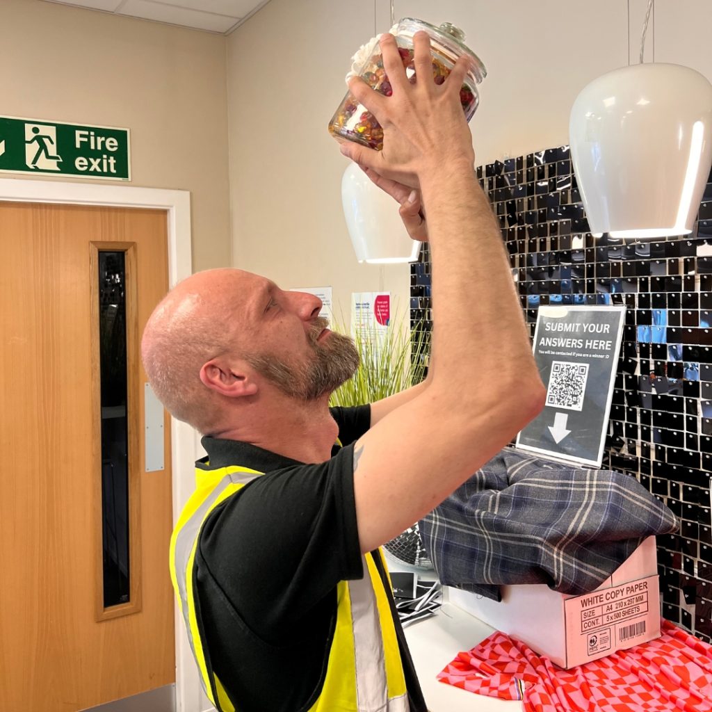 ACS Team Member Arek inspecting the Jar of Sweets