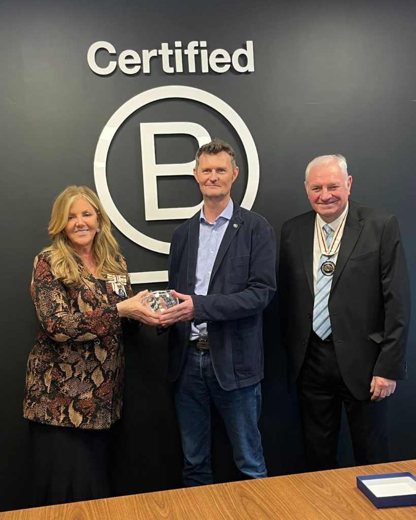 Lord Lieutenant, Lady Susan Haughey (Left) and Depute Terry Currie (Right) presenting Andrew Rough, CEO of ACS (Centre), with the King's Award for Enterprise onsite at the ACS Circular Fashion Hub.The Award resembles a glass bowl with the King's Award for Excellence logo on the front, noting that it is the award for the Sustainable Development category.