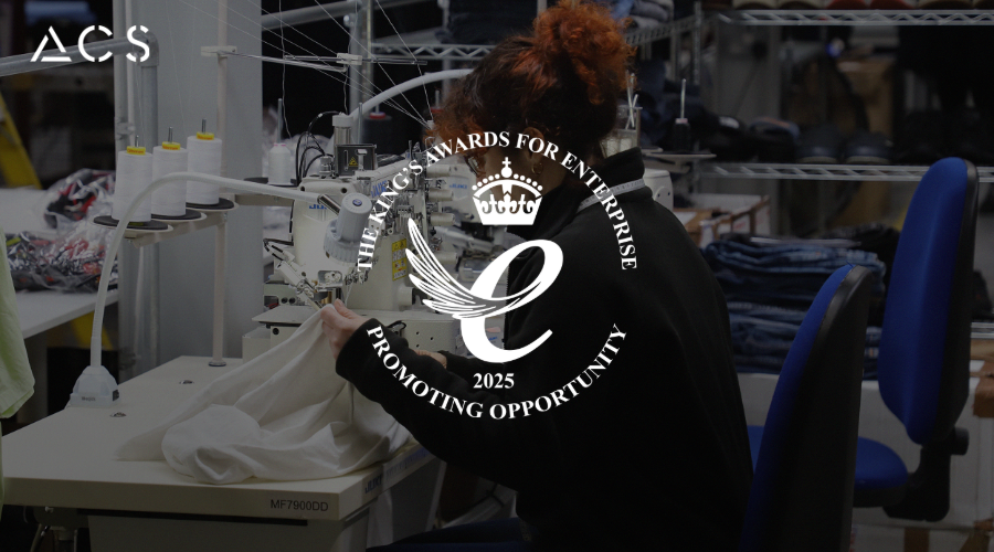 Kings Award for Enterprise in Promoting Opportunity 2025 Emblem on top of ACS facility image of machinist at a sewing machine with ACS Clothing logo in top left.